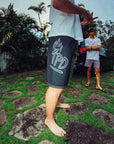 black - right side view of mens faceplant y2k fit 22" boardshort in black showing large IPD graphic on right side thigh 