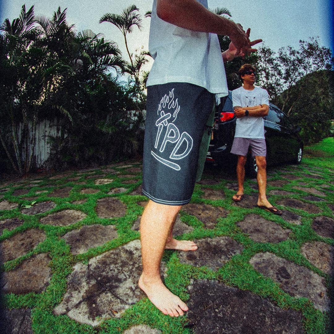 black - right side view of mens faceplant y2k fit 22&quot; boardshort in black showing large IPD graphic on right side thigh 