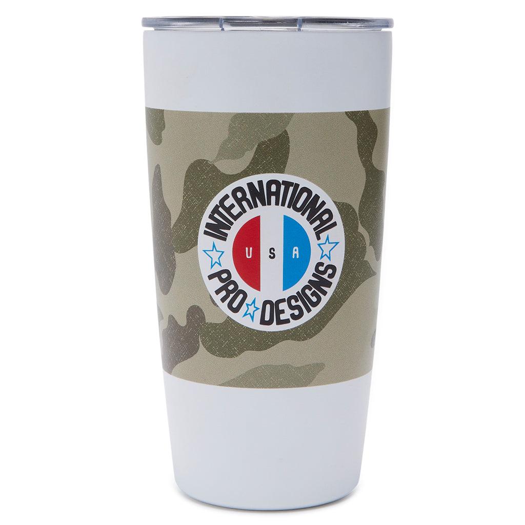 americana tumbler in camo behind the international pro designs logo with USA within circle - front view 