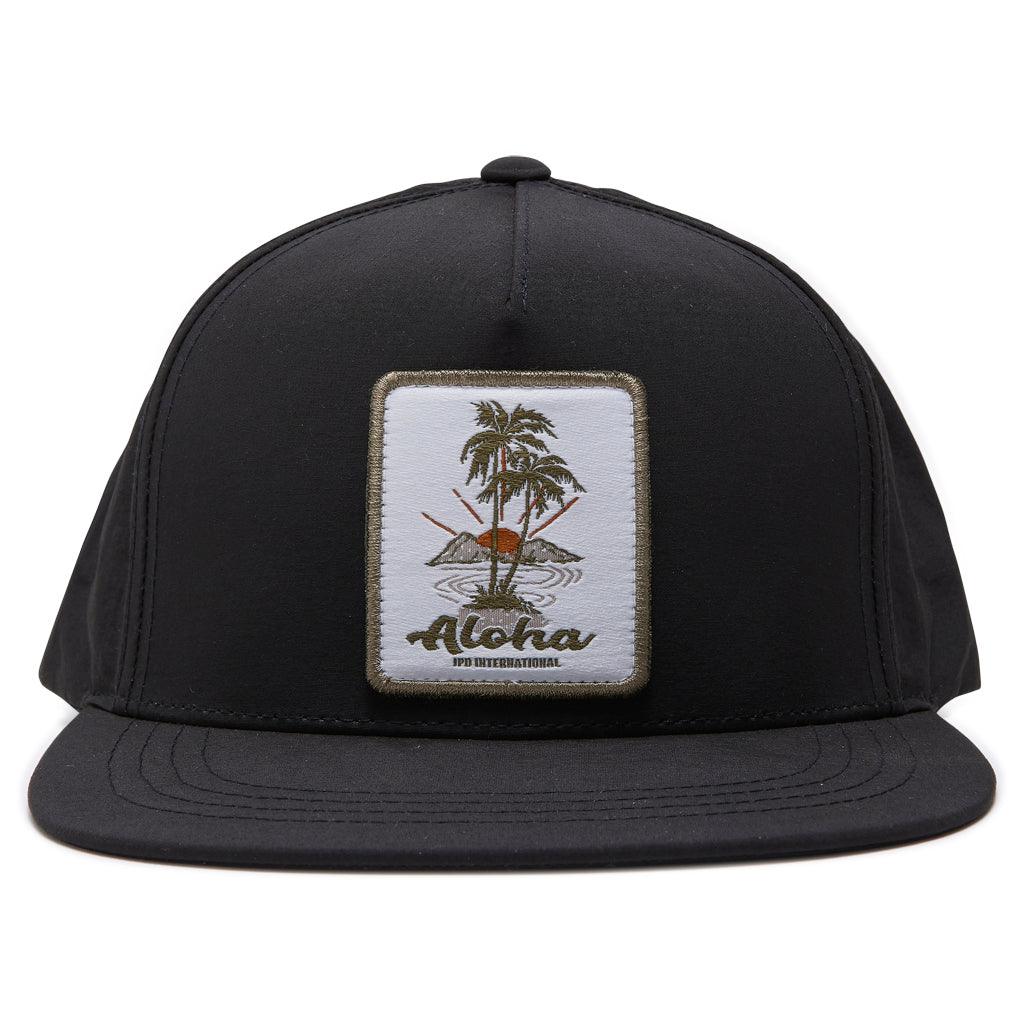 black snapback hat with aloha and two palm trees logo on the print in a patch 