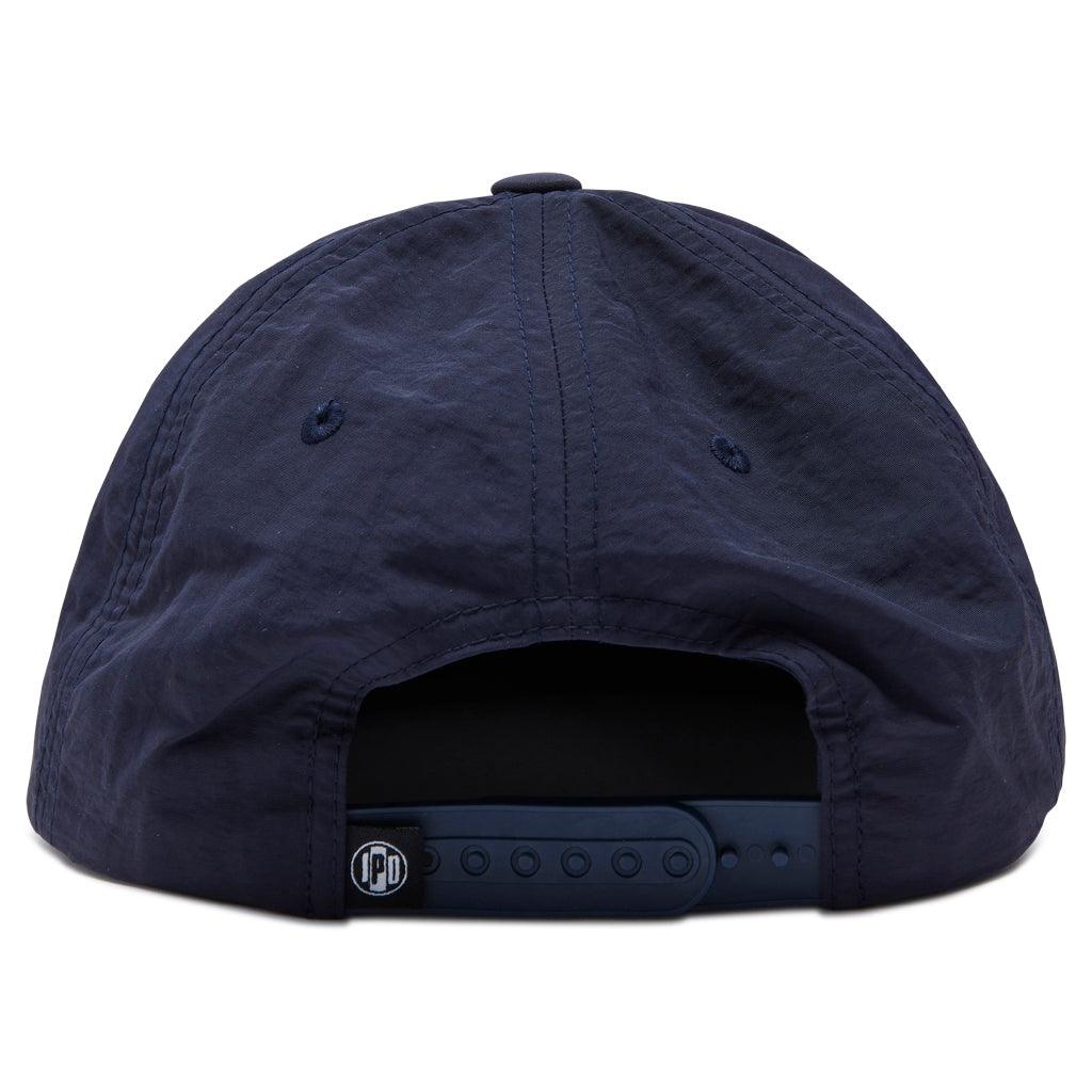 rear view of aloha hat in navy showing back two panels and snap closure 