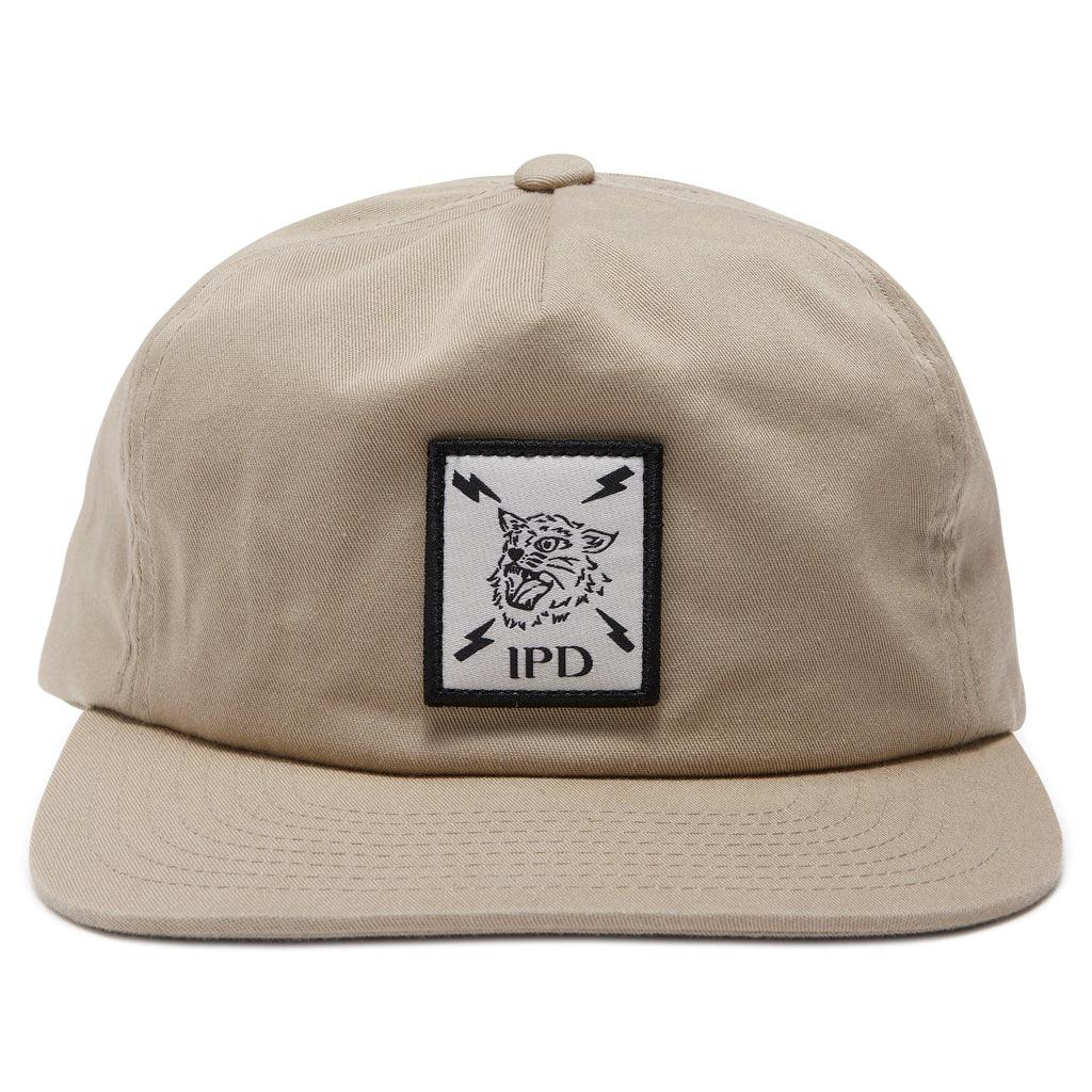 front view of five panel bolts unstructured snapback in khaki - showing logo of tiger head surrounded by four lightening bolts within a square 