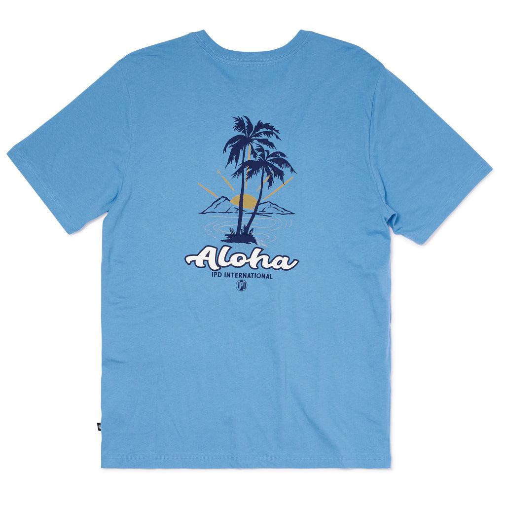 rear view of mens aloha shirt in Banjo blue, large logo on back that matches front. Aloha in white letters in front of palm trees, IPD international with logo below