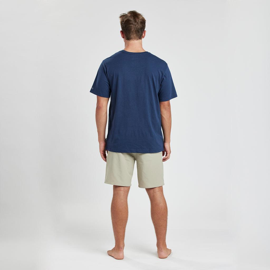 model wearing mens short sleeve tee in navy showing plain back of shirt