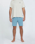 The front view of a man wearing blue shorts with two side pockets.