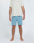 The front view of a man wearing blue shorts with two side pockets.