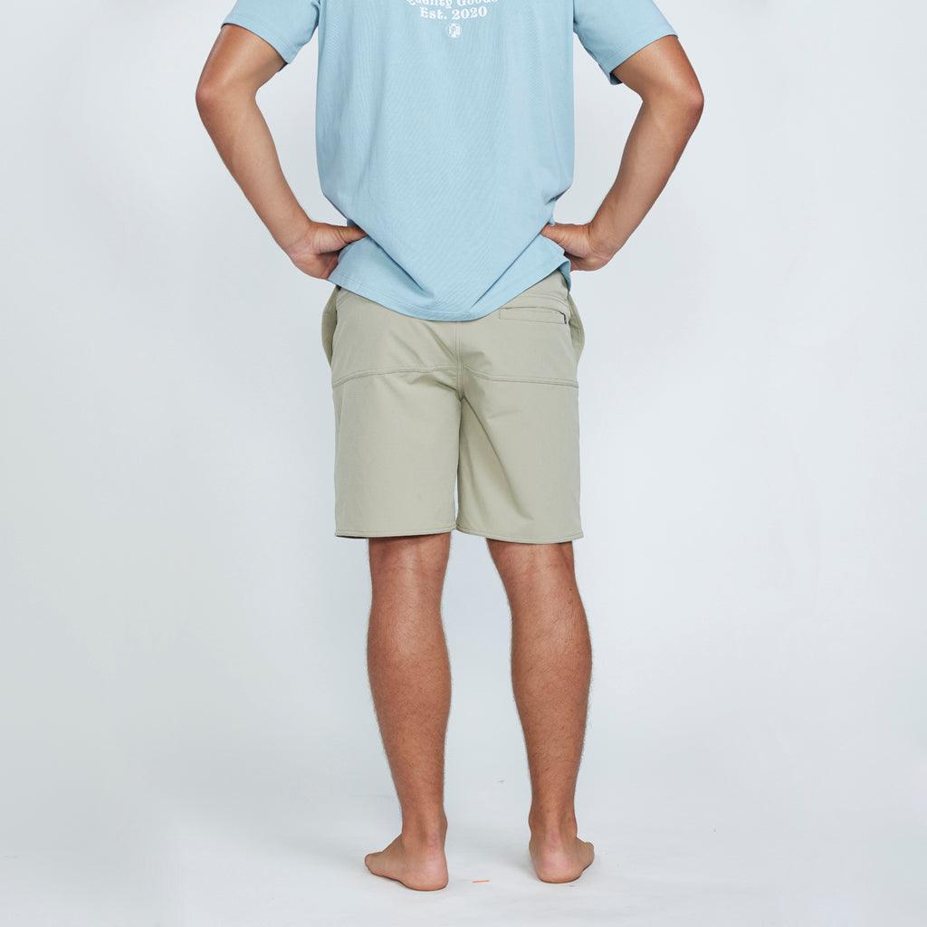 The back view of tan shorts with a pocket on the right side. 