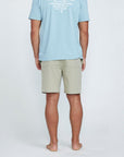 The back view of tan shorts with a pocket on the right side.