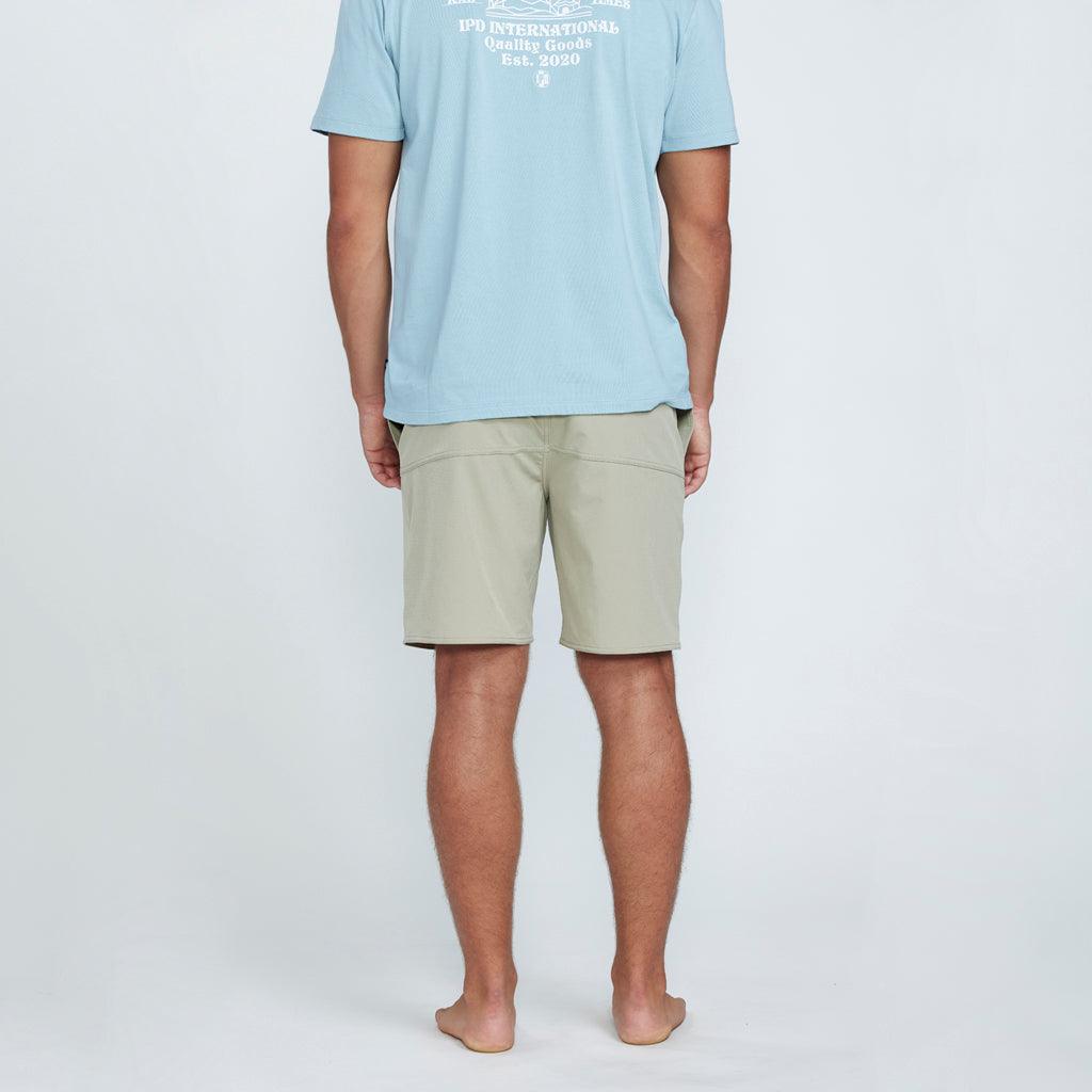 The back view of tan shorts with a pocket on the right side.