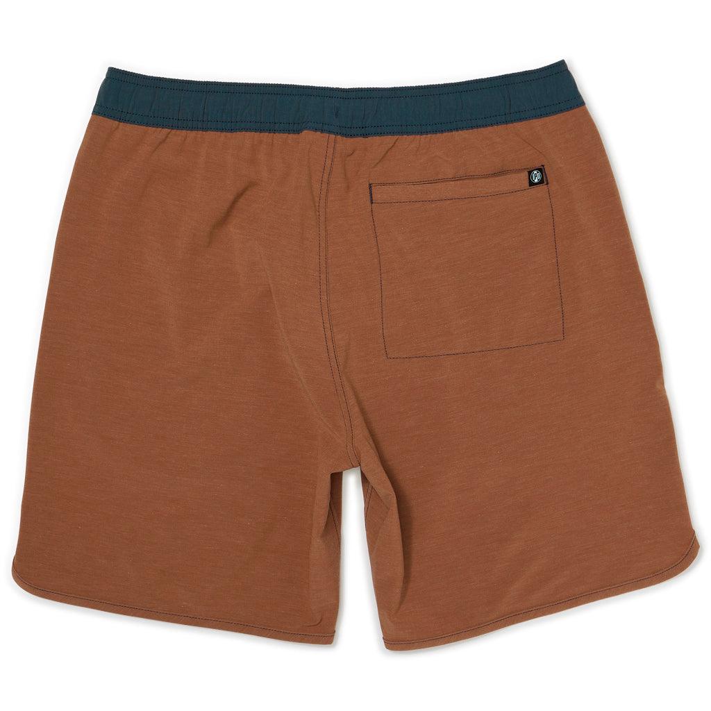 Front of lightweight clay red boardshorts with navy blue waistband.