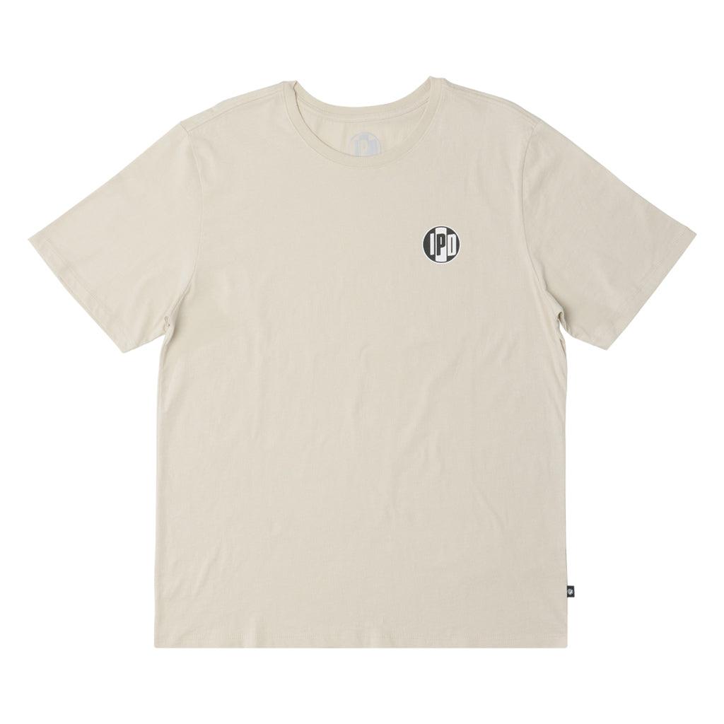 The Surf Shop Super Soft Tee has a left chest front graphic of the IPD logo in black and light blue. The back pictures a hand-drawn depiction of a surf shop across the upper middle back of the shirt. The body color of the shirt is haze and the graphic color is multicolored and has a small black side seam label with the IPD logo.