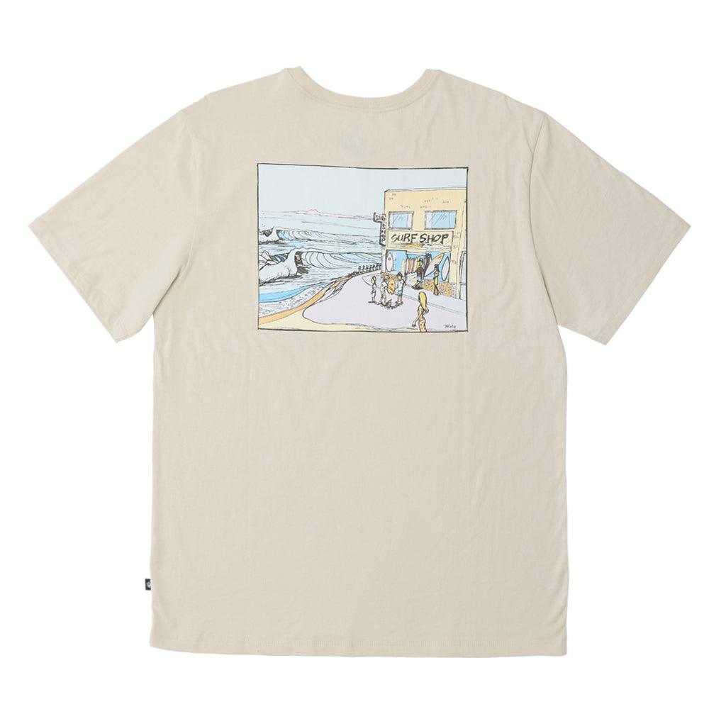 The Surf Shop Super Soft Tee has a left chest front graphic of the IPD logo in black and light blue. The back pictures a hand-drawn depiction of a surf shop across the upper middle back of the shirt. The body color of the shirt is haze and the graphic color is multicolored and has a small black side seam label with the IPD logo.