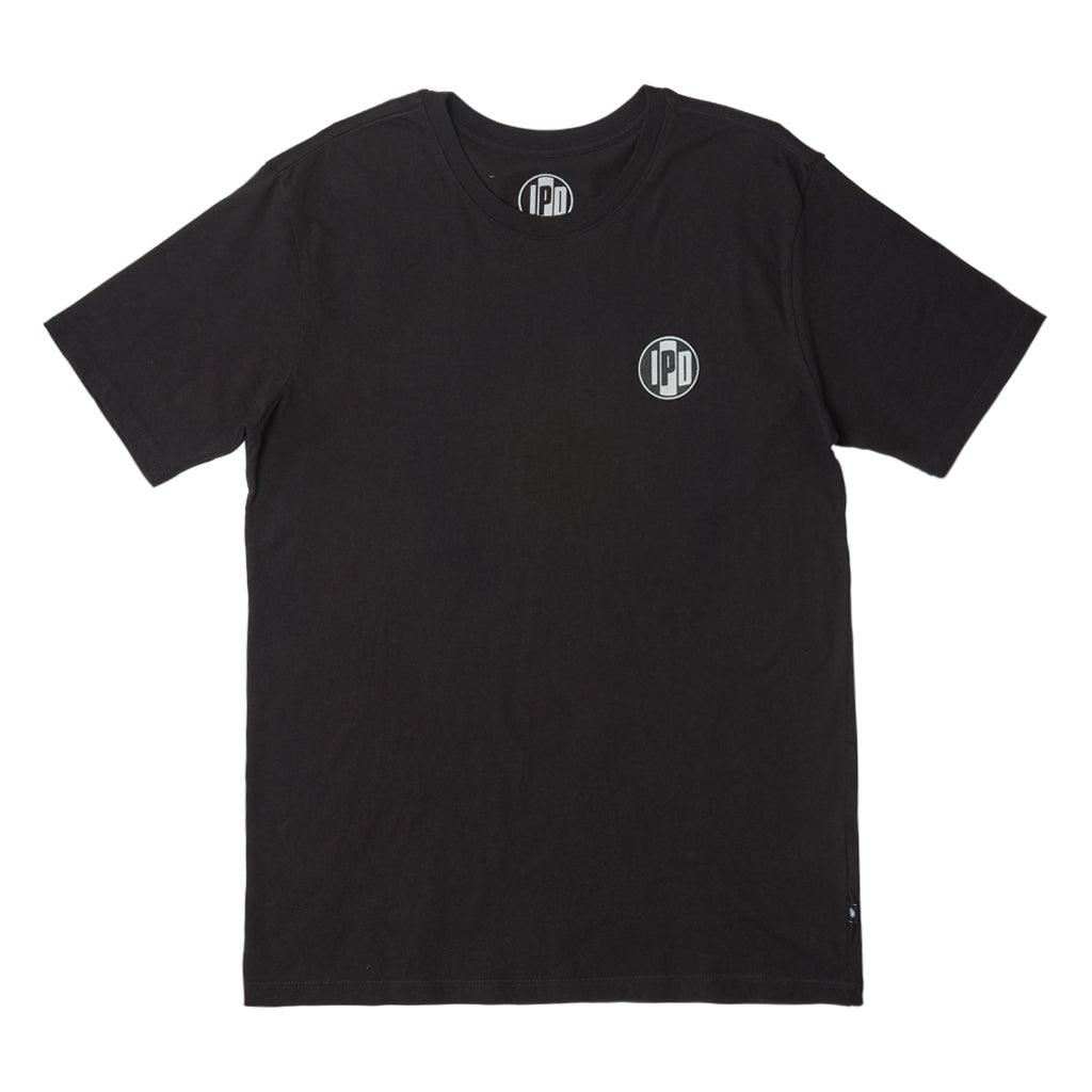 The Surf Shop Super Soft Tee has a left chest front graphic of the IPD logo in black and light blue. The back pictures a hand-drawn depiction of a surf shop across the upper middle back of the shirt. The body color of the shirt is black and the graphic color is multicolored and has a small black side seam label with the IPD logo.