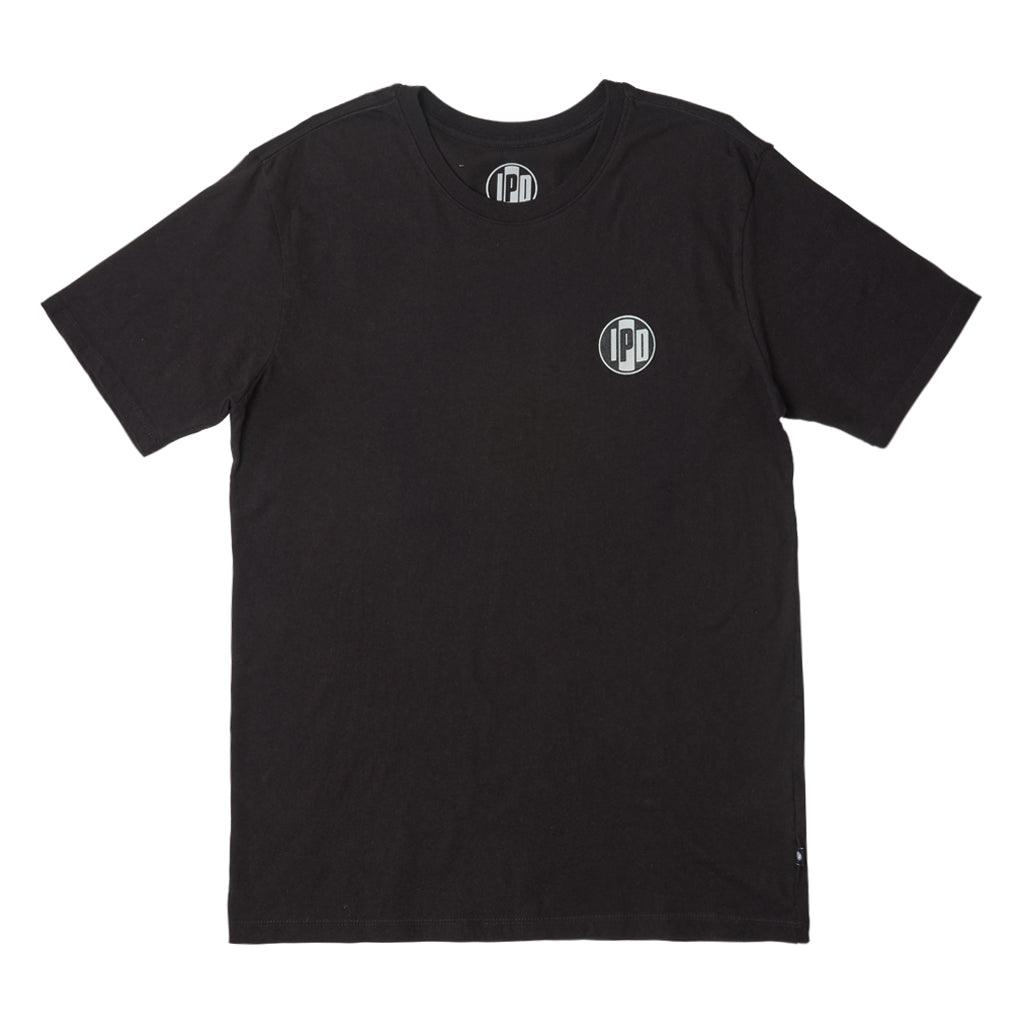 The Surf Shop Super Soft Tee has a left chest front graphic of the IPD logo in black and light blue. The back pictures a hand-drawn depiction of a surf shop across the upper middle back of the shirt. The body color of the shirt is haze and the graphic color is multicolored and has a small black side seam label with the IPD logo.