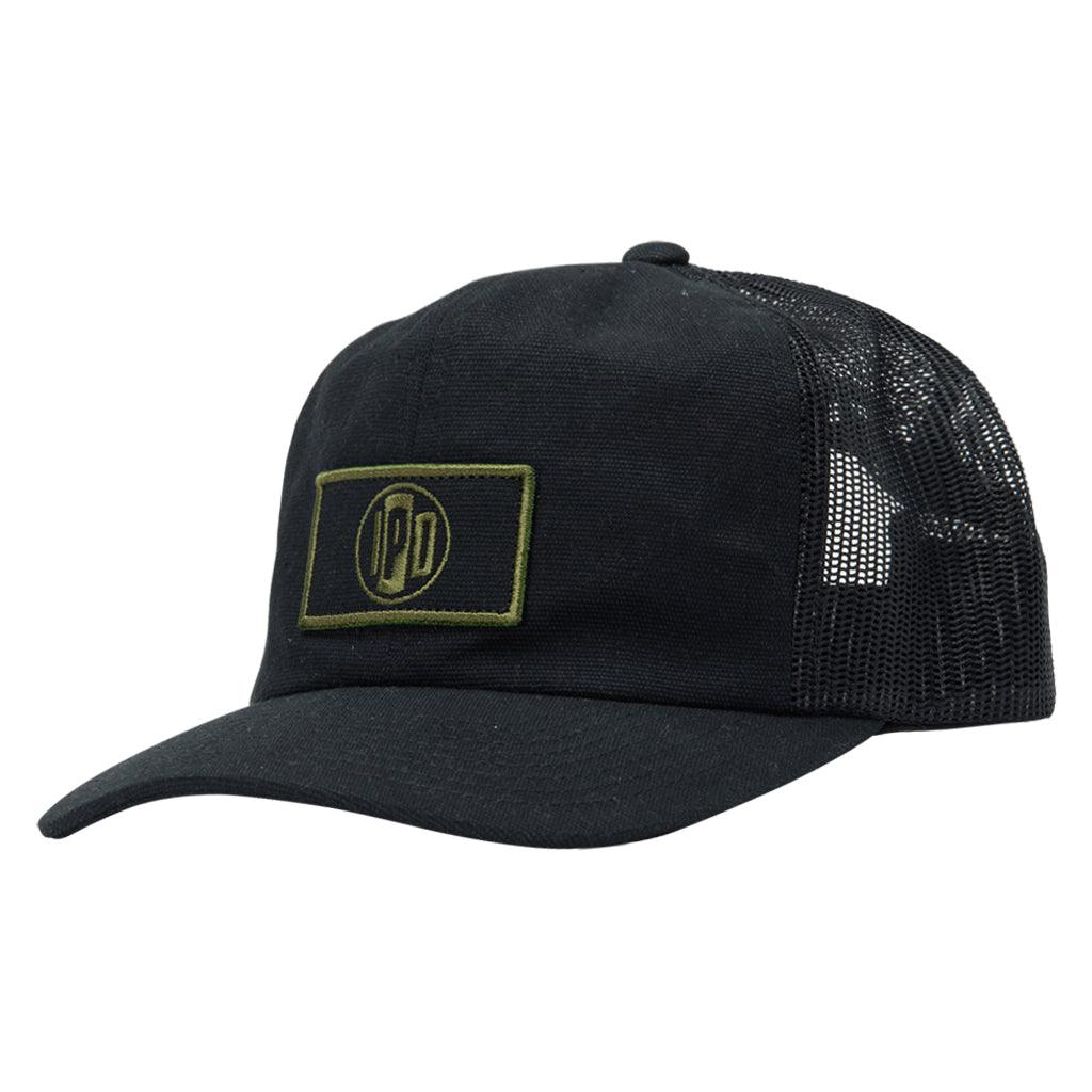 The 1697 Trucker Snapback features a lower profile trucker styling in the color black with a black mesh back. It features a white and navy rectangular front patch.