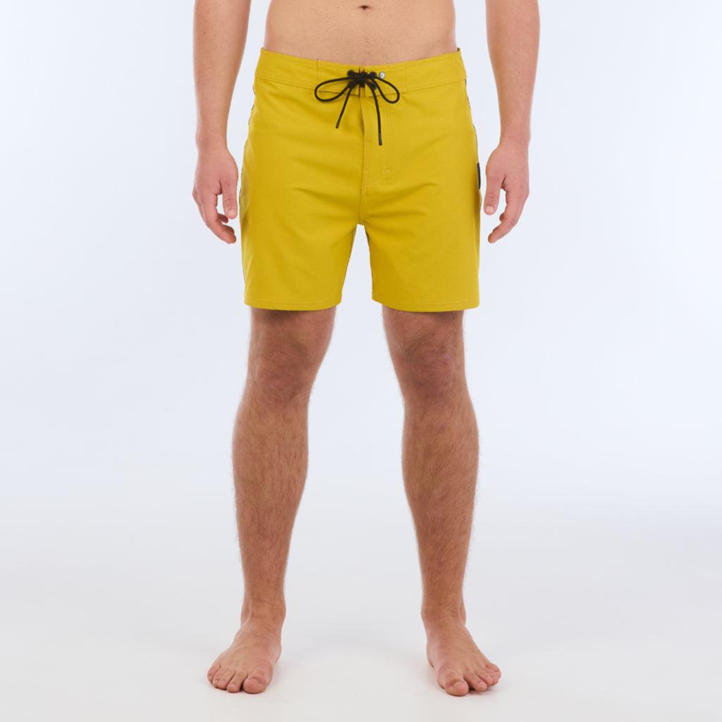 The B100 Chase boardshort features a 16” length and solid yellow coloring with a black and white striped side taping. It also has a waistband tie, side zipper pocket, and a black IPD logo patch halfway up the left leg taping. 
