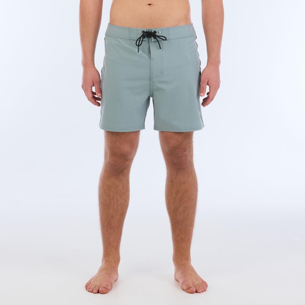 The B100 Chase boardshort features a 16” length and solid sage coloring with a black and white striped side taping. It also has a waistband tie, side zipper pocket, and a black IPD logo patch halfway up the left leg taping.  