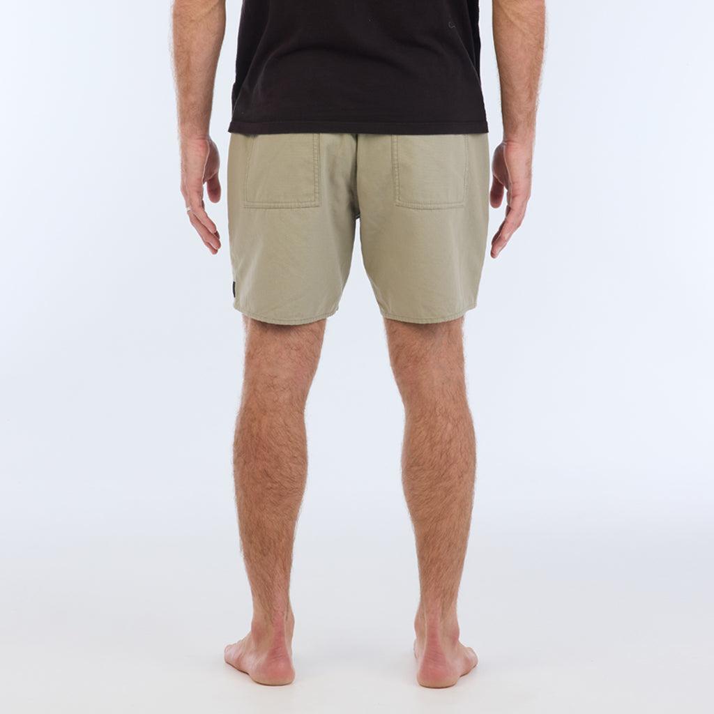 on model with black top. back view:The Foundation Walkshort is a classic walkshort silhouette that comes in at a 17” length. It features a solid gray coloring, and features an elastic waistband and drawcord. The pocketing is two side pockets and two back patch pockets. It features the signature smaller IPD flag label on the lower left leg.