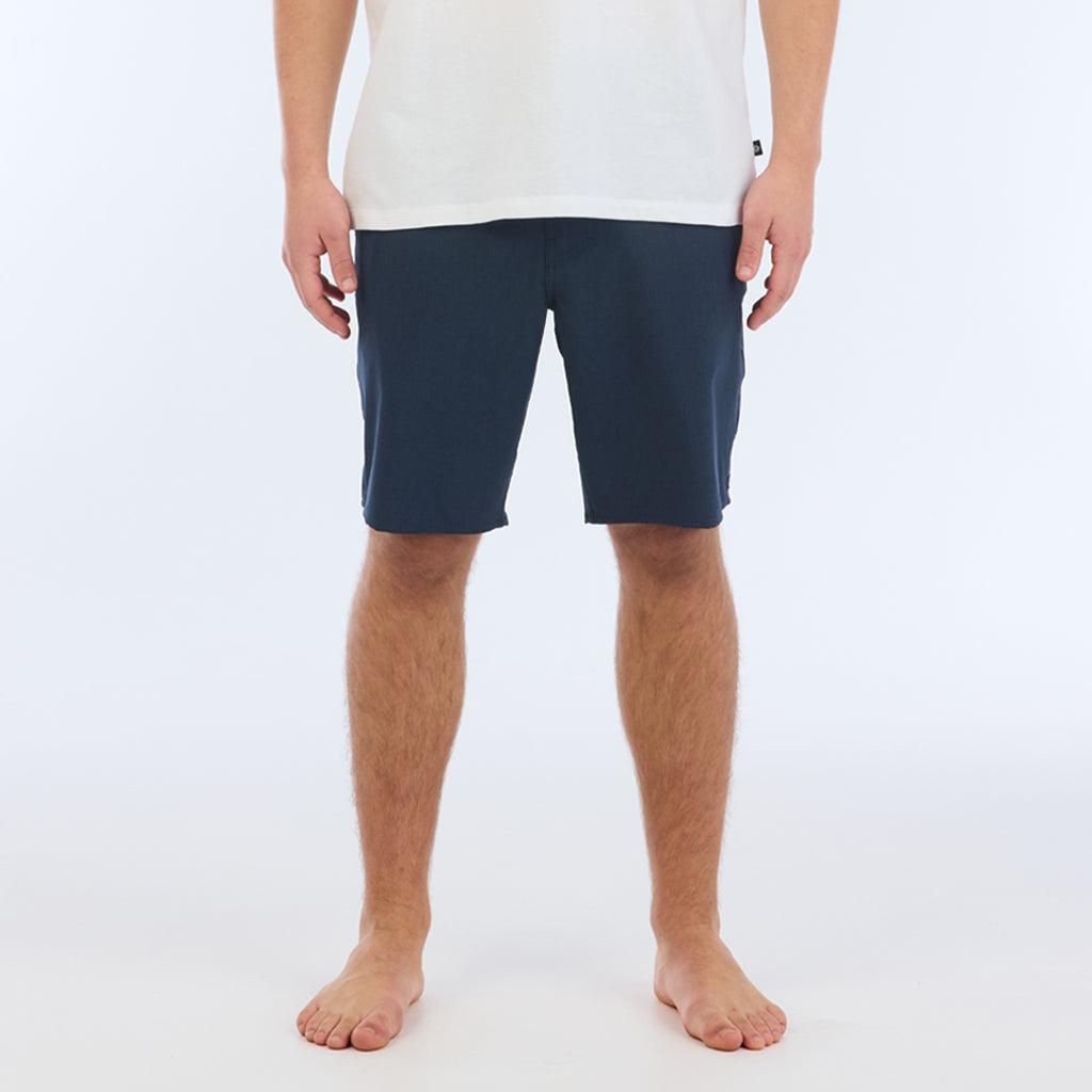 The Carter Hybrid features a 19” length in a classic walkshort silhouette in a waterproof fabric. The base color of the short is a heathered navy. The short also features belt loops, a zipper and button closure, two side pockets and two back pockets, and the signature smaller IPD flag label on the lower left leg.