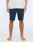 The Carter Hybrid features a 19” length in a classic walkshort silhouette in a waterproof fabric. The base color of the short is a heathered navy. The short also features belt loops, a zipper and button closure, two side pockets and two back pockets, and the signature smaller IPD flag label on the lower left leg.