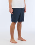 The Carter Hybrid features a 19” length in a classic walkshort silhouette in a waterproof fabric. The base color of the short is a heathered navy. The short also features belt loops, a zipper and button closure, two side pockets and two back pockets, and the signature smaller IPD flag label on the lower left leg.