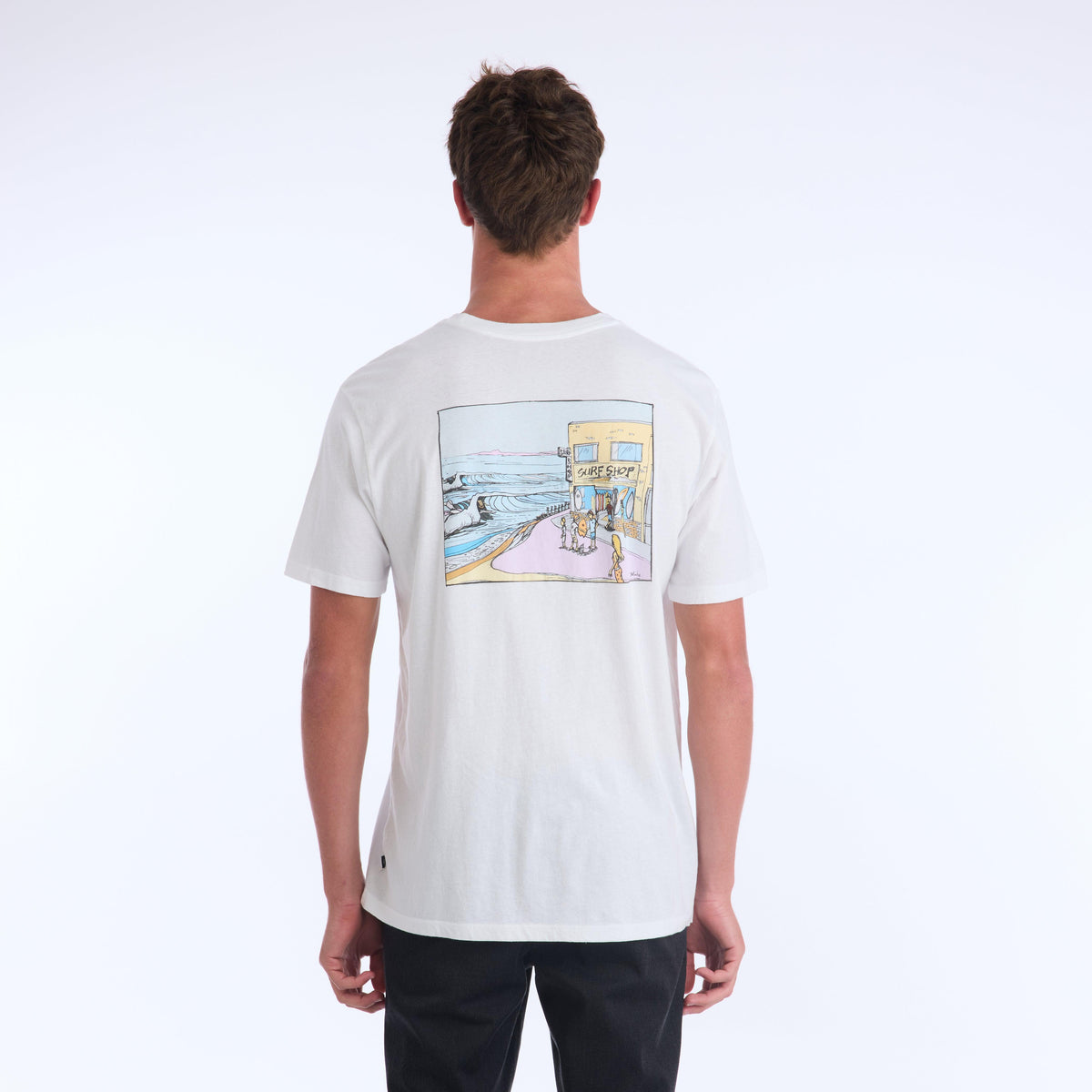 The Surf Shop Super Soft Tee has a left chest front graphic of the IPD logo in black and light blue. The back pictures a hand-drawn depiction of a surf shop across the upper middle back of the shirt. The body color of the shirt is white and the graphic color is multicolored and has a small black side seam label with the IPD logo.