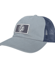 The side view of a 5-panel, unstructured, billed hat with a rectangular dark grey patch featuring the I P D logo. The hat is light grey on the front two panels and a bluish-grey mesh on the remaining panels.